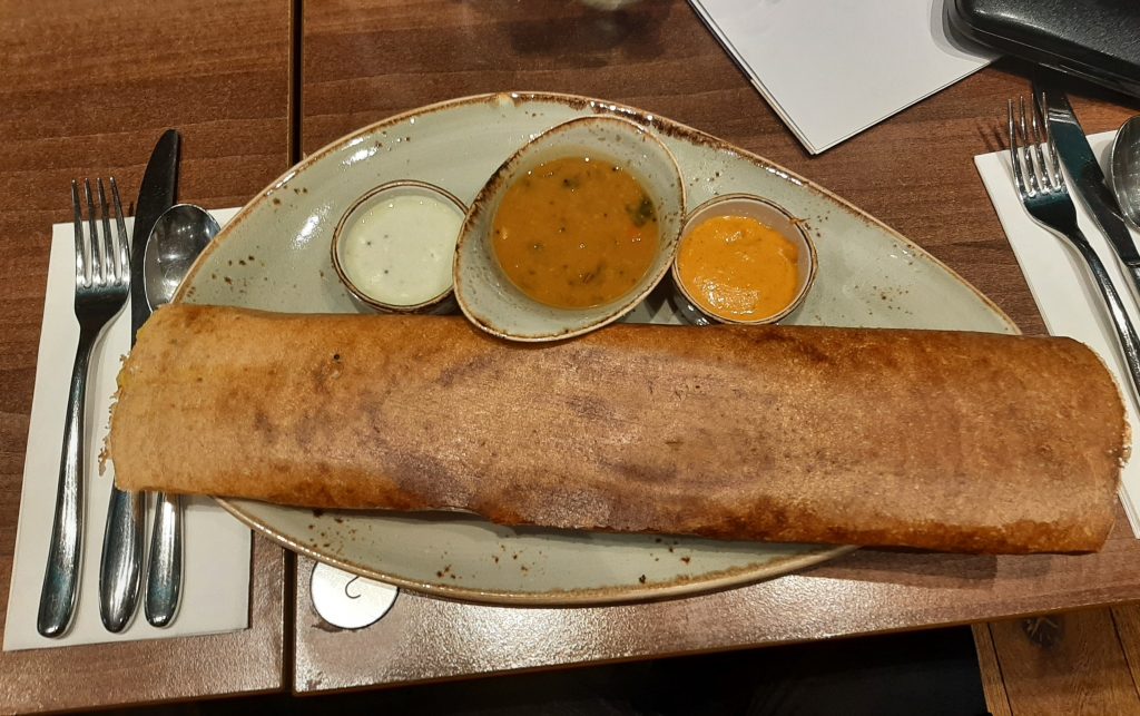 Mysore Masala Dosai (Vg) – A large, crispy crepe filled with fragrant potato masala, served with chutneys and sambar. 