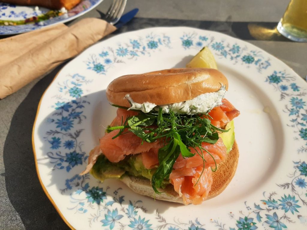 Smoked Salmon Brioche Bagel, filled with velvety cream cheese and slices of ripe avocado, all layered with delicately smoked salmon.