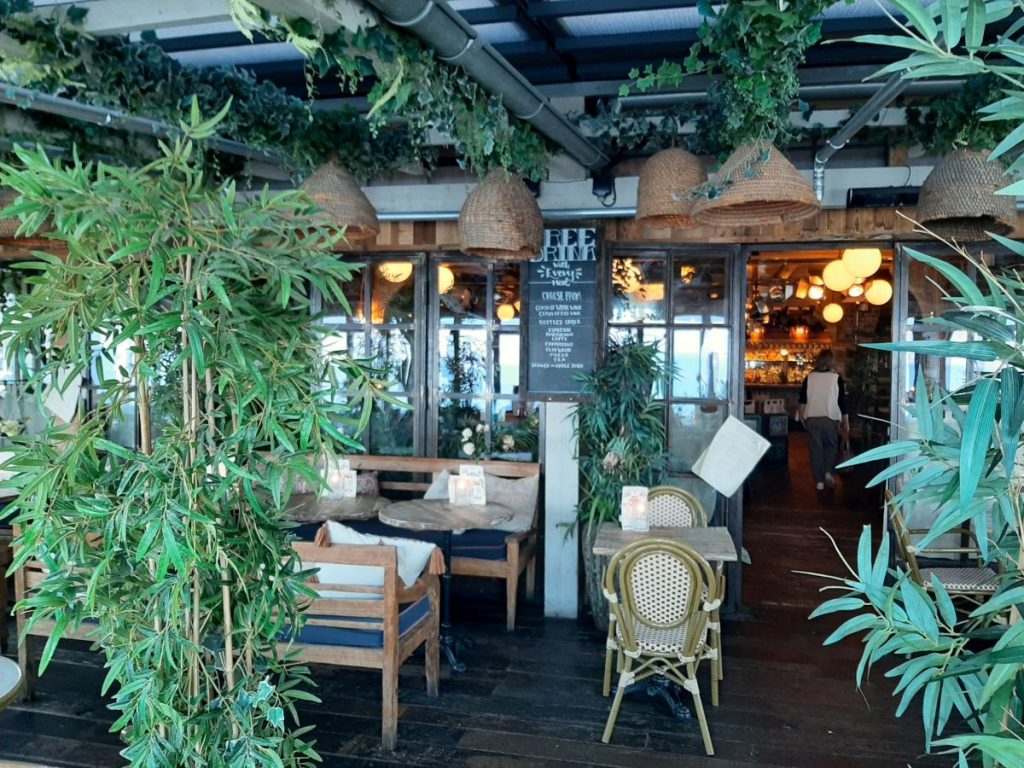 Seating with seafront views at the Gin & Juice Mumbles Swansea