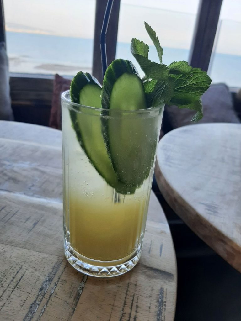 A Summer Breeze. It was made with Penrhos Apple & Elderflower Gin, cucumber, mint, lime, sugar, and soda water at the Gin & Juice Mumbles Swansea