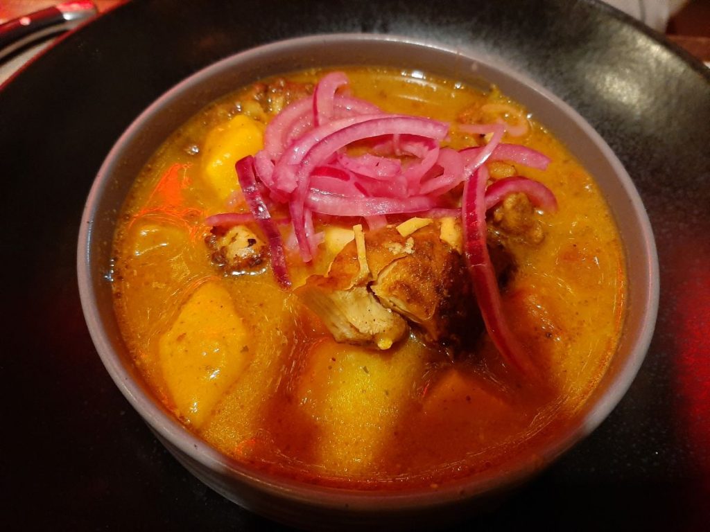 Turtle Bay Swansea: Trinidad Coconut Chicken Curry - A slow-simmered coconut chicken curry with ginger and garlic.