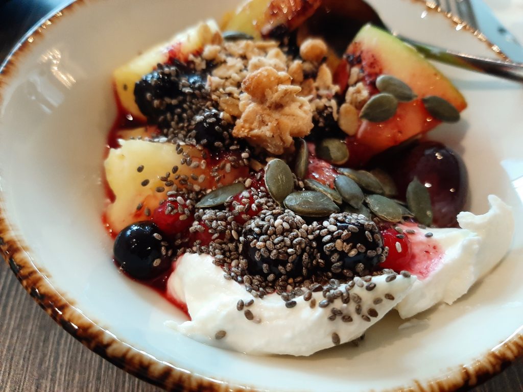 Breakfast: Fresh fruit, Greek yogurt, granola, and mixed seeds at the Hilton London Wembley.