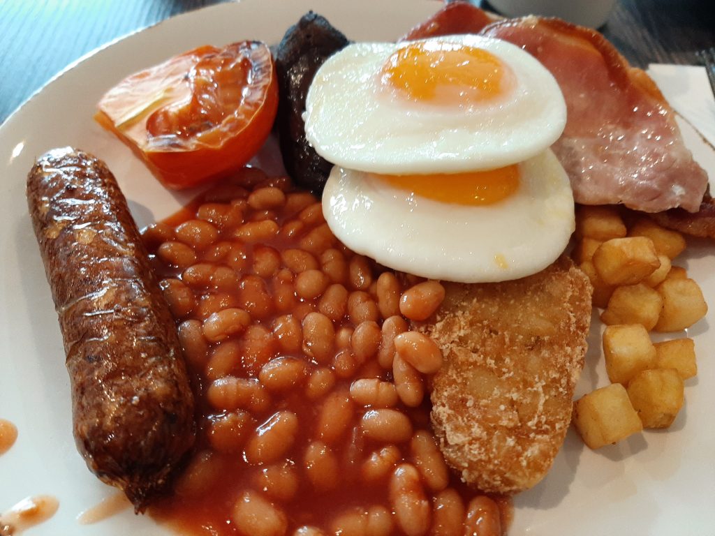 Breakfast: Bacon, sausage, eggs, grilled tomatoes, mushrooms, and hash browns at the Hilton London Wembley.