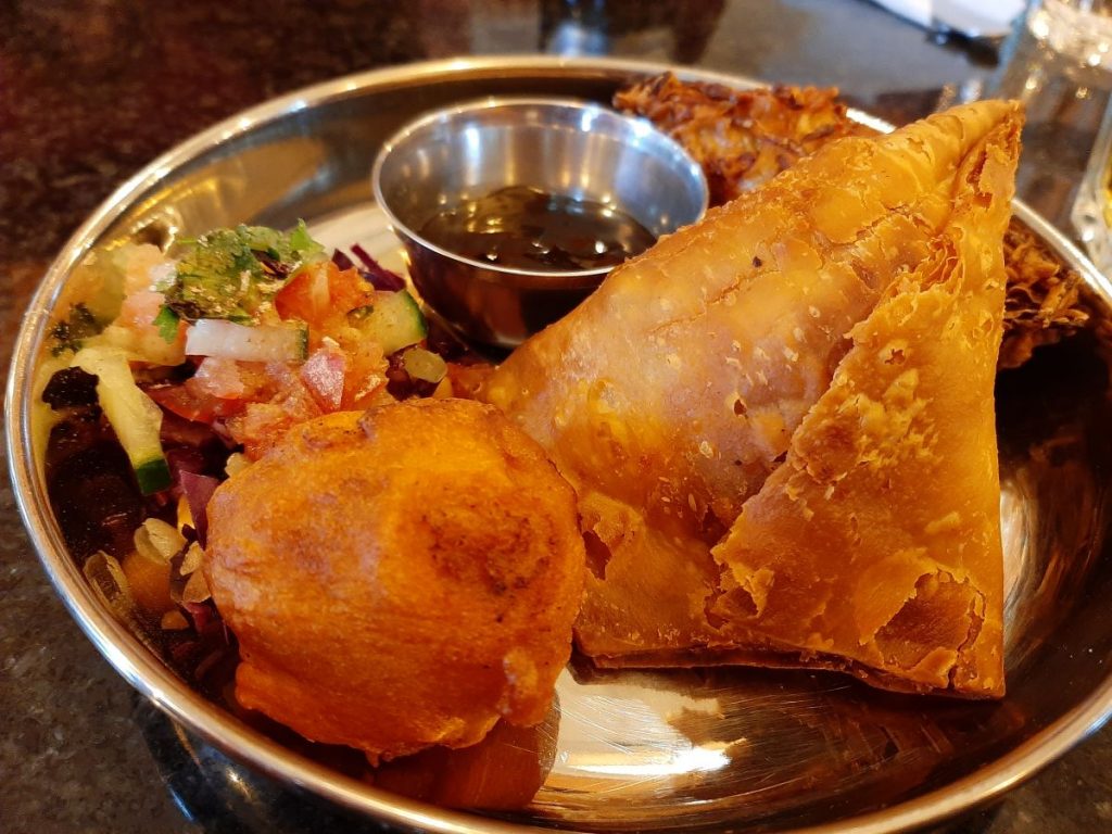 Savoury Plate featuring a trio of fried savouries served with chutneys.