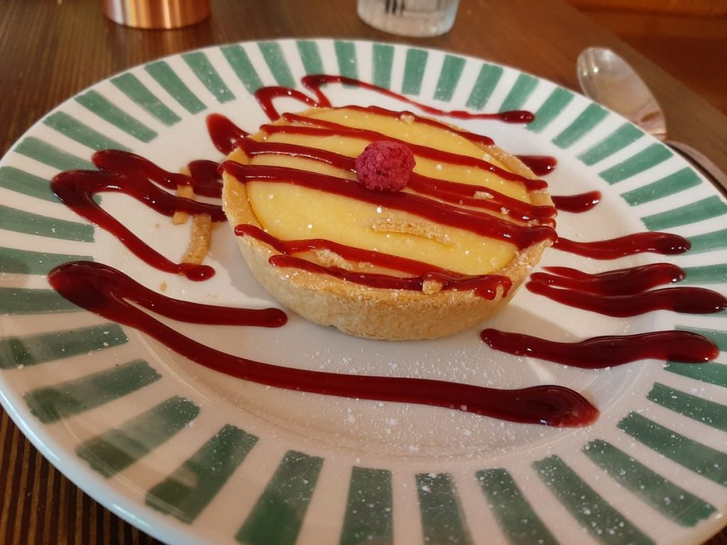Sicilian Lemon Tart, served with a mixed berry coulis.